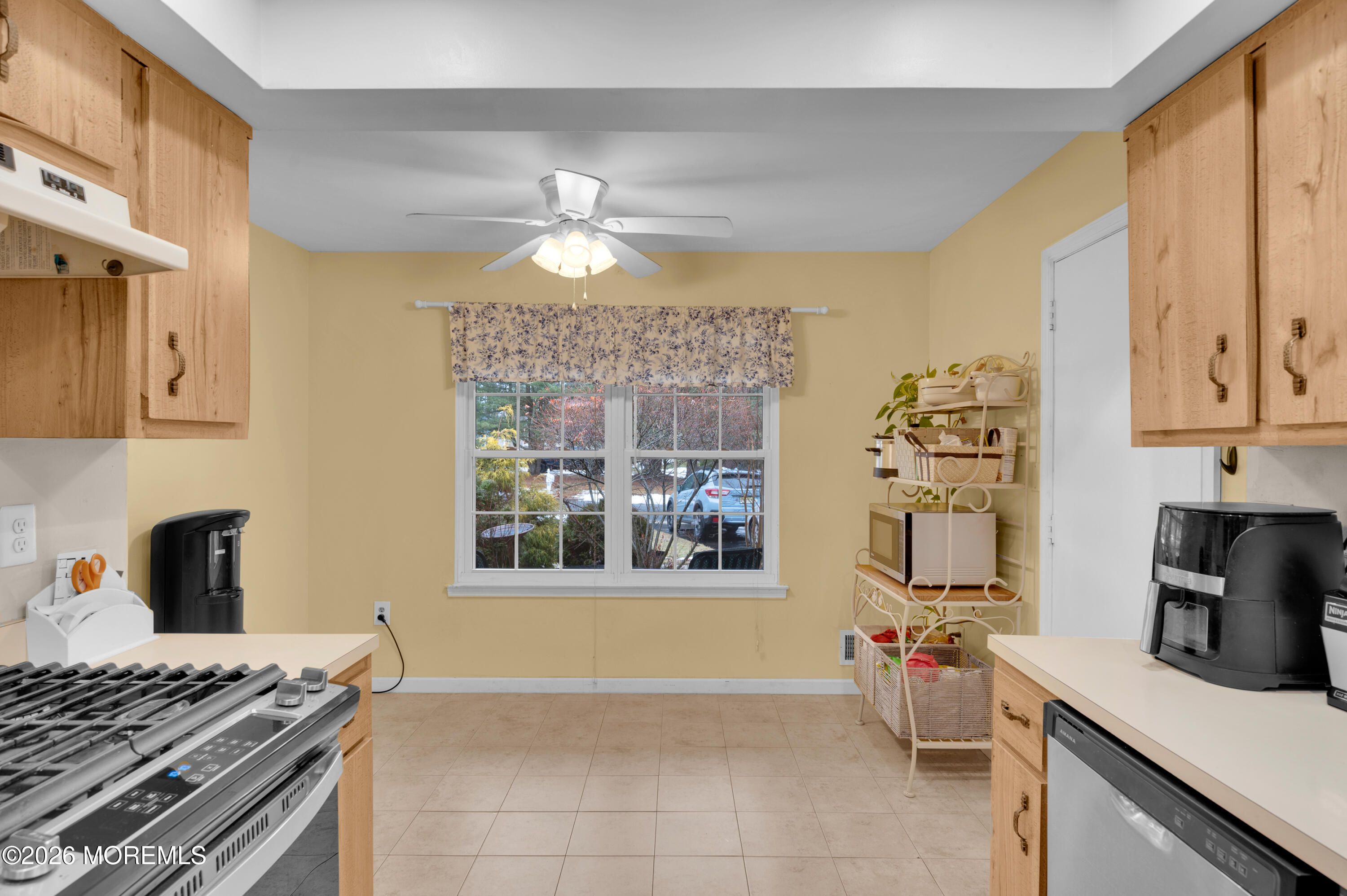 7 Deck Court Howell, NJ 07731 - Photo 20 of 29 a kitchen with stainless steel appliances granite countertop a stove top oven a sink a dining table and chairs