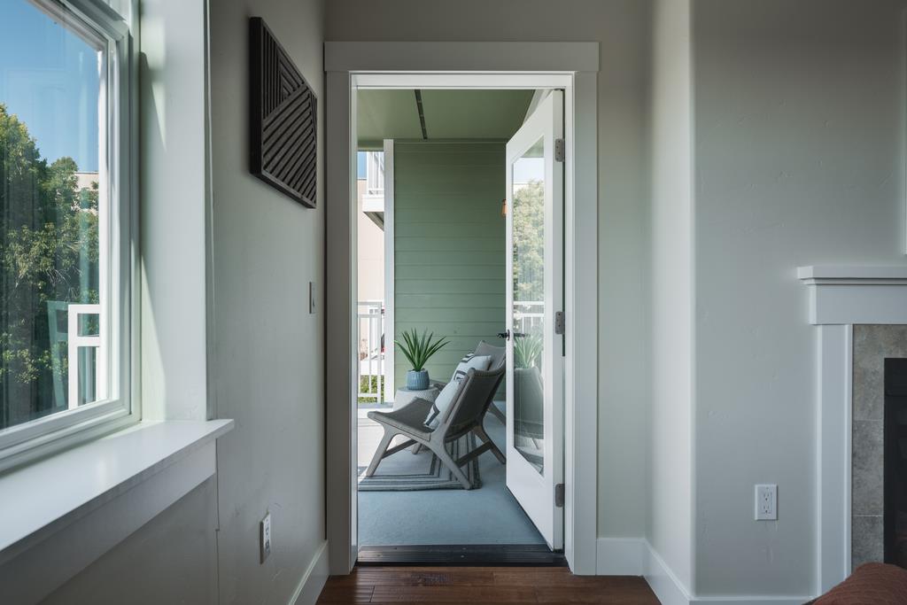 708 Frederick Street, Unit 204 Santa Cruz, CA 95062 - Photo 11 of 34 a view of a hallway with wooden floor and a livingroom