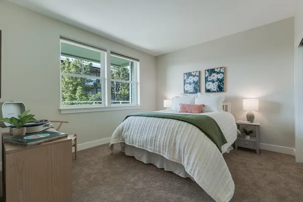 a bedroom with a large bed and a large window