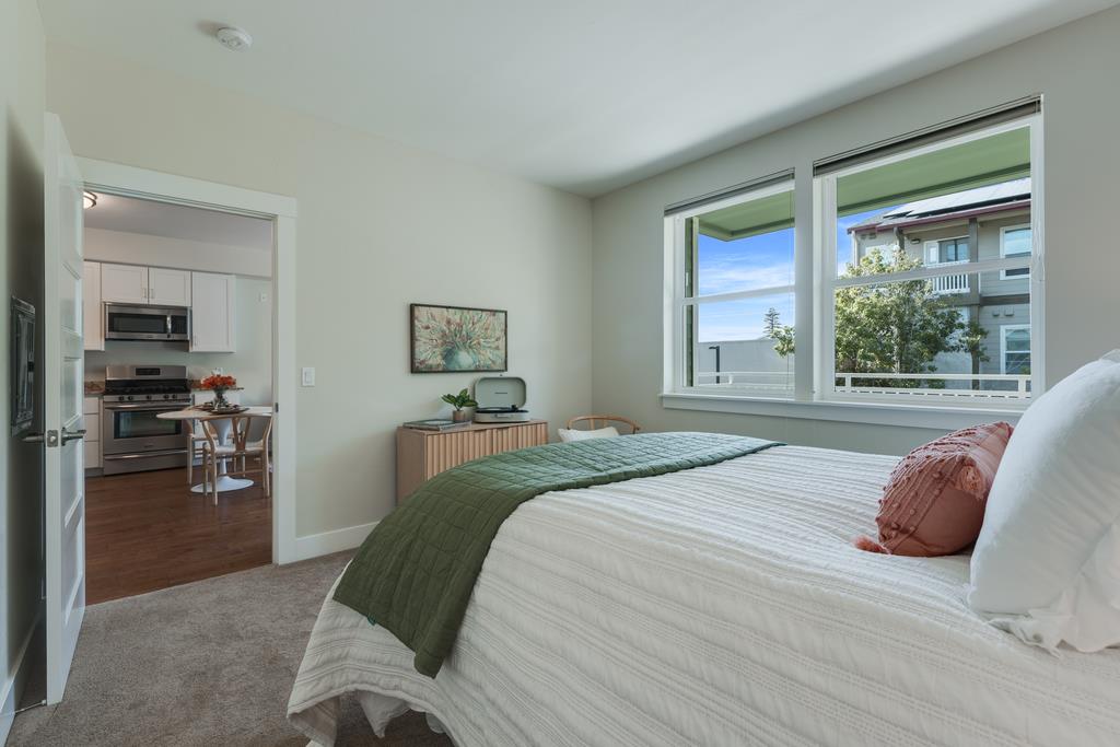 708 Frederick Street, Unit 204 Santa Cruz, CA 95062 - Photo 15 of 34 a bedroom with a large bed and a large window