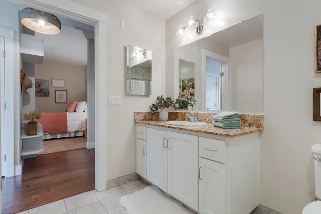 a large bed sitting in a bedroom next to a window
