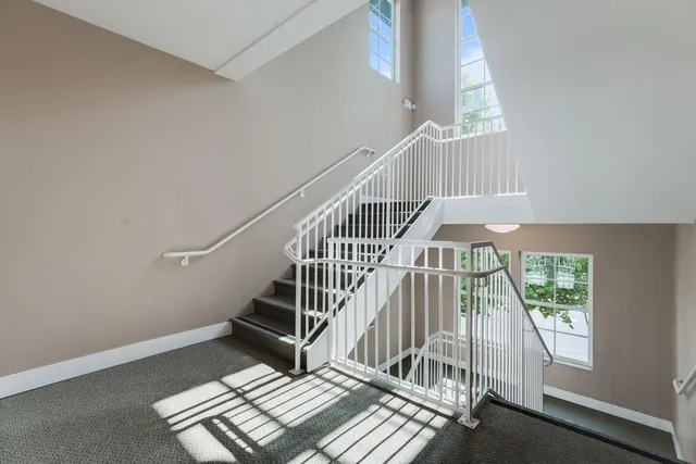 a living room with furniture a fireplace and a large window