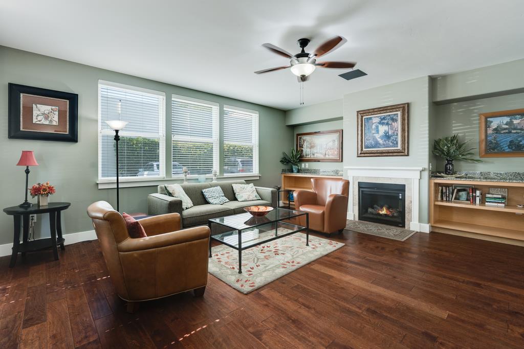 708 Frederick Street, Unit 204 Santa Cruz, CA 95062 - Photo 28 of 34 a living room with furniture a fireplace and a large window