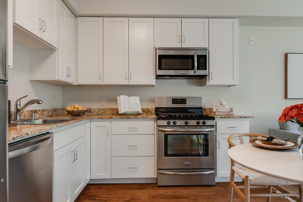 708 Frederick Street, Unit 204 Santa Cruz, CA 95062 - Photo 6 of 34 a kitchen with white cabinets and stainless steel appliances