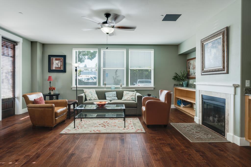 708 Frederick Street, Unit 204 Santa Cruz, CA 95062 - Photo 8 of 34 a living room with furniture a large window and a fireplace