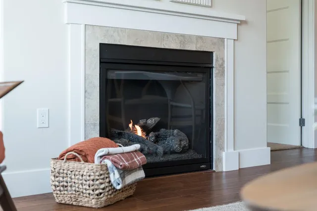 a living room with furniture fireplace and table