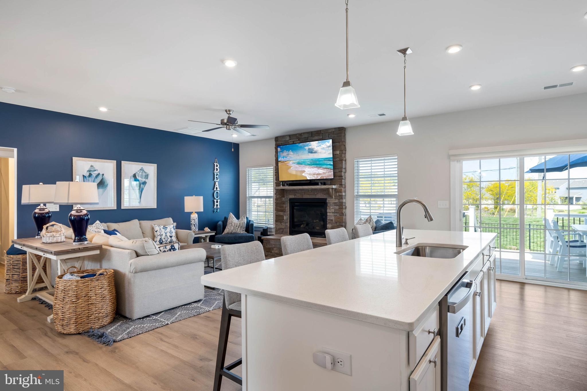 19016 Trimaran Drive Lewes, DE 19958 - Photo 15 of 44 a large living room with fireplace furniture and a large window