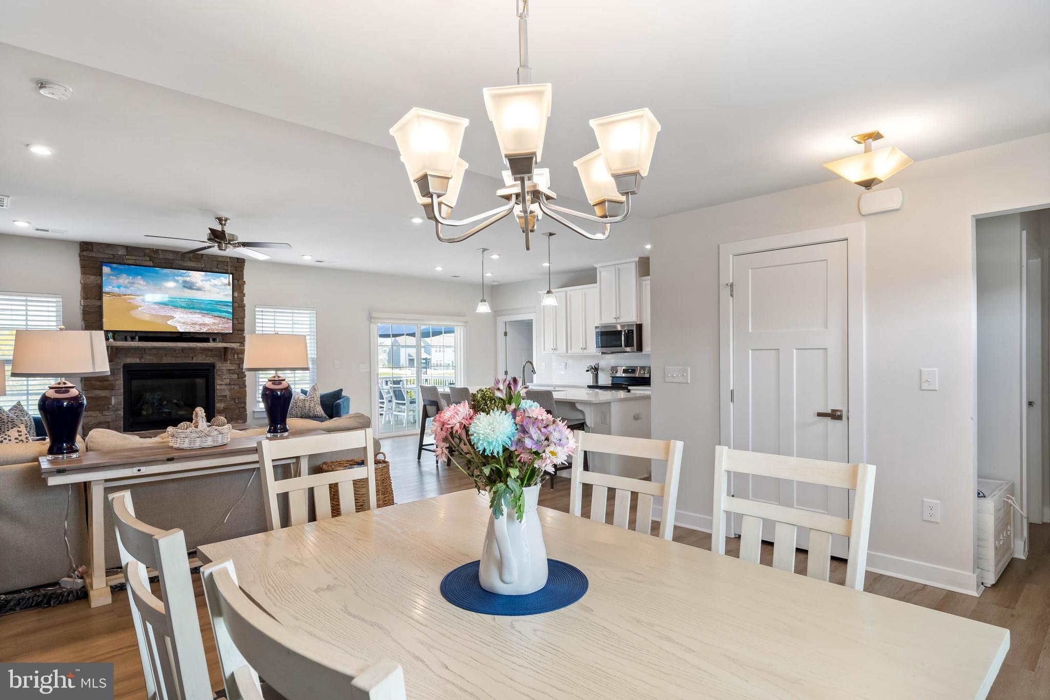 19016 Trimaran Drive Lewes, DE 19958 - Photo 17 of 44 a kitchen with stainless steel appliances kitchen island granite countertop a table and chairs in it