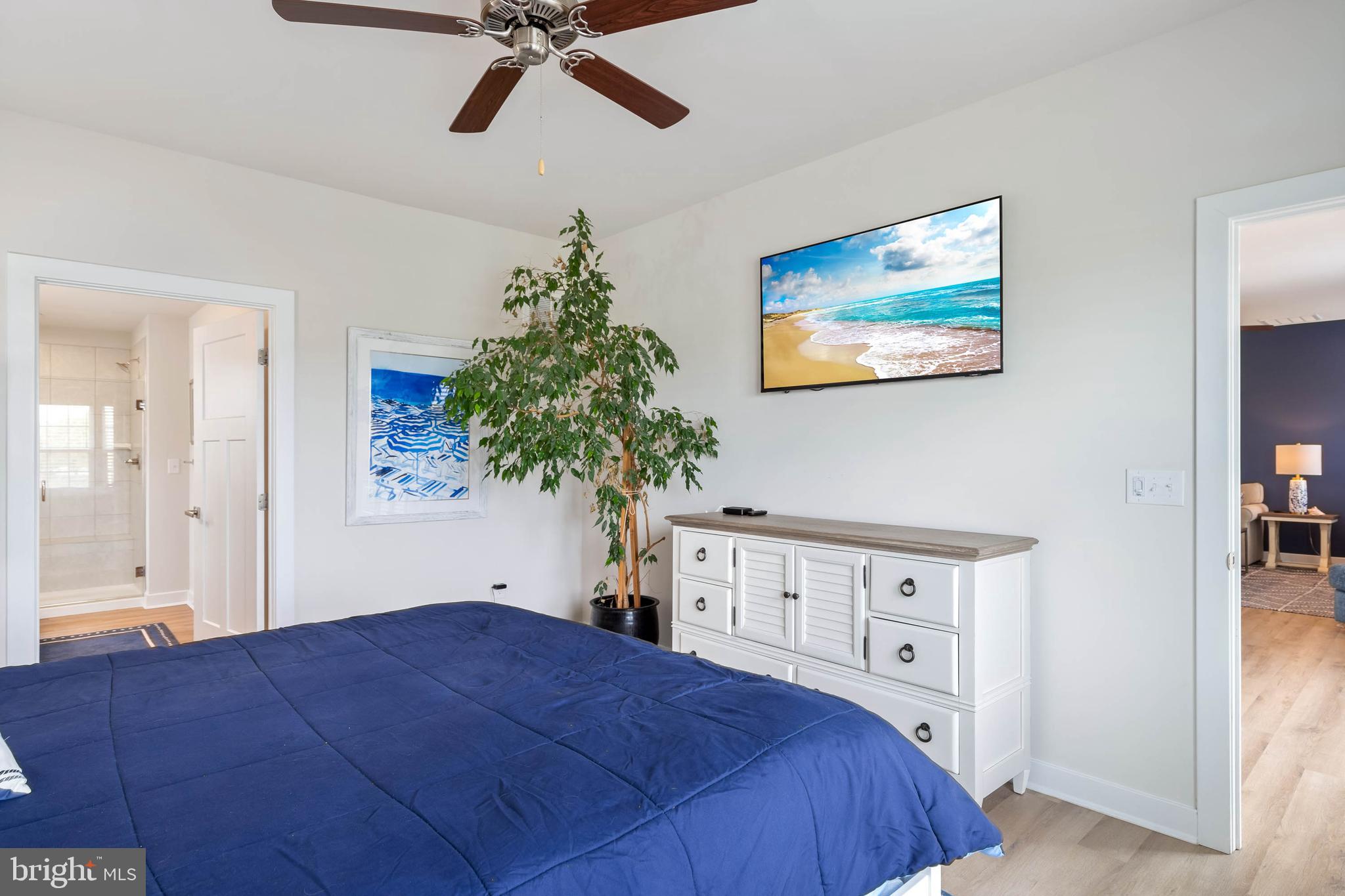 19016 Trimaran Drive Lewes, DE 19958 - Photo 19 of 44 a bedroom with a bed and a potted plant
