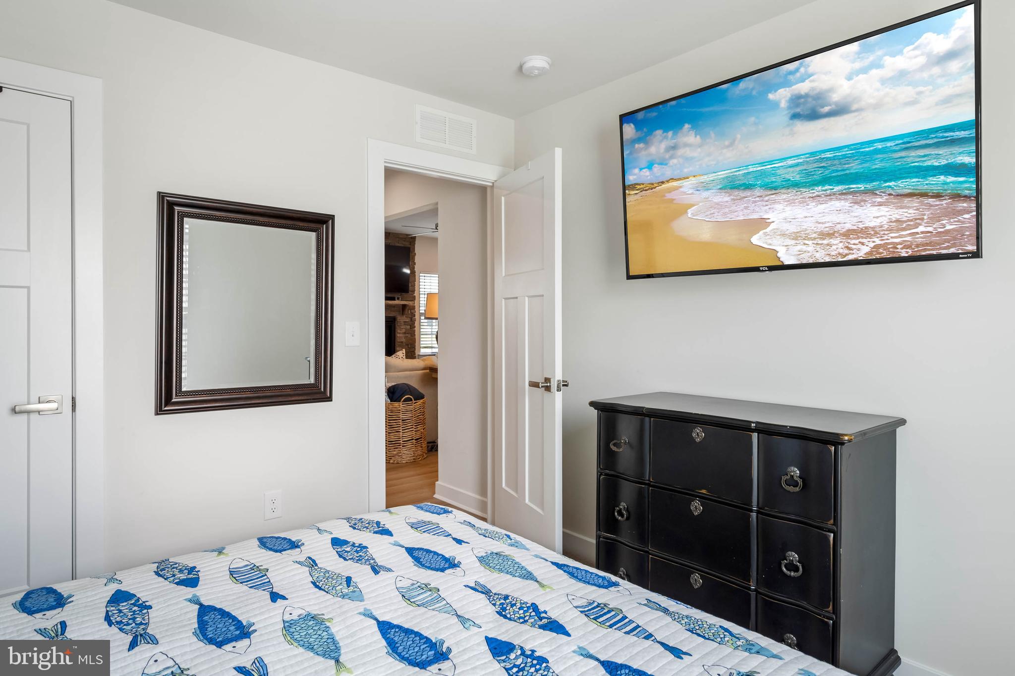 19016 Trimaran Drive Lewes, DE 19958 - Photo 25 of 44 a bedroom with a bed and a lamp on dresser