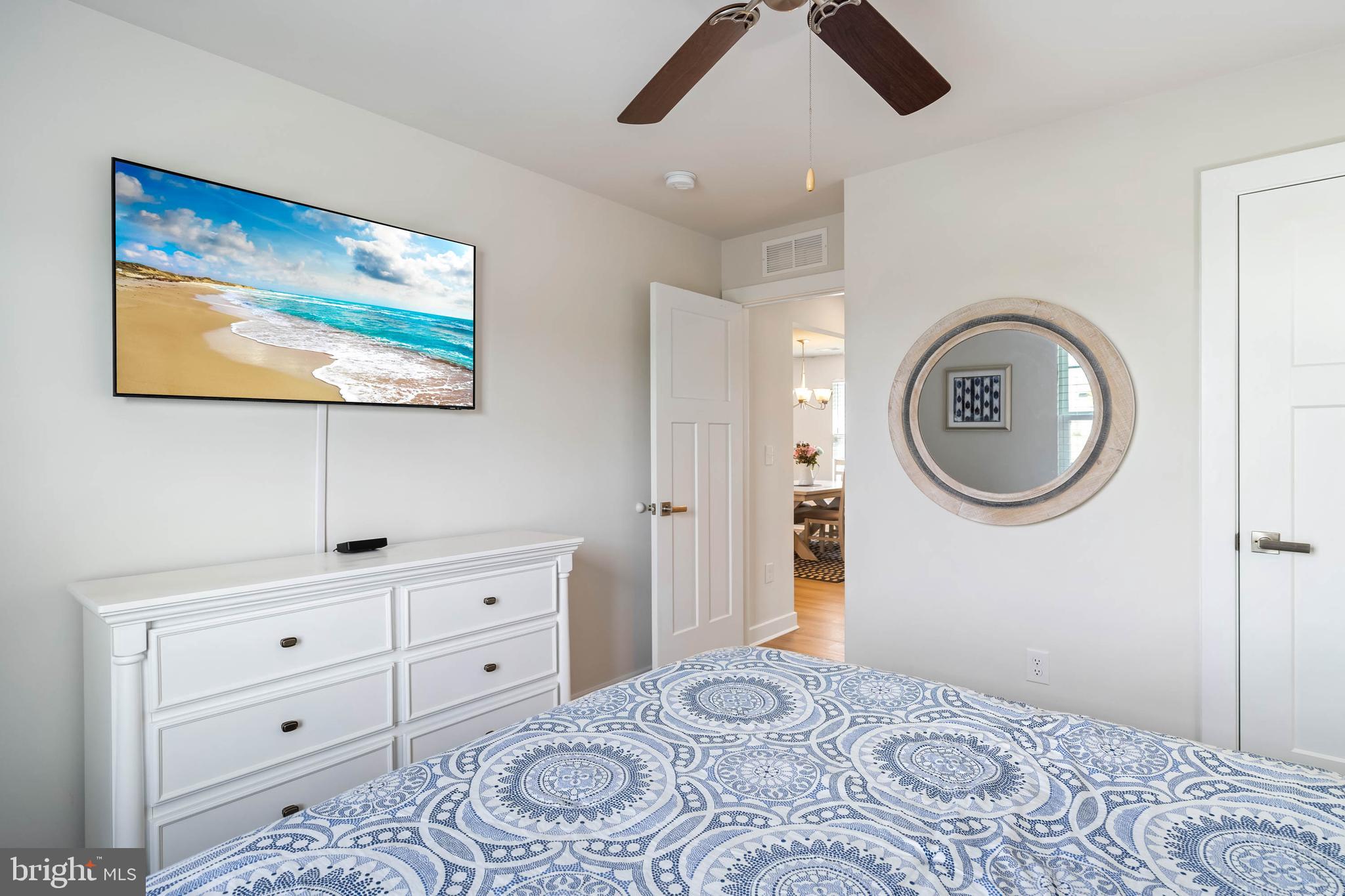 19016 Trimaran Drive Lewes, DE 19958 - Photo 28 of 44 a bedroom with a bed and a chandelier