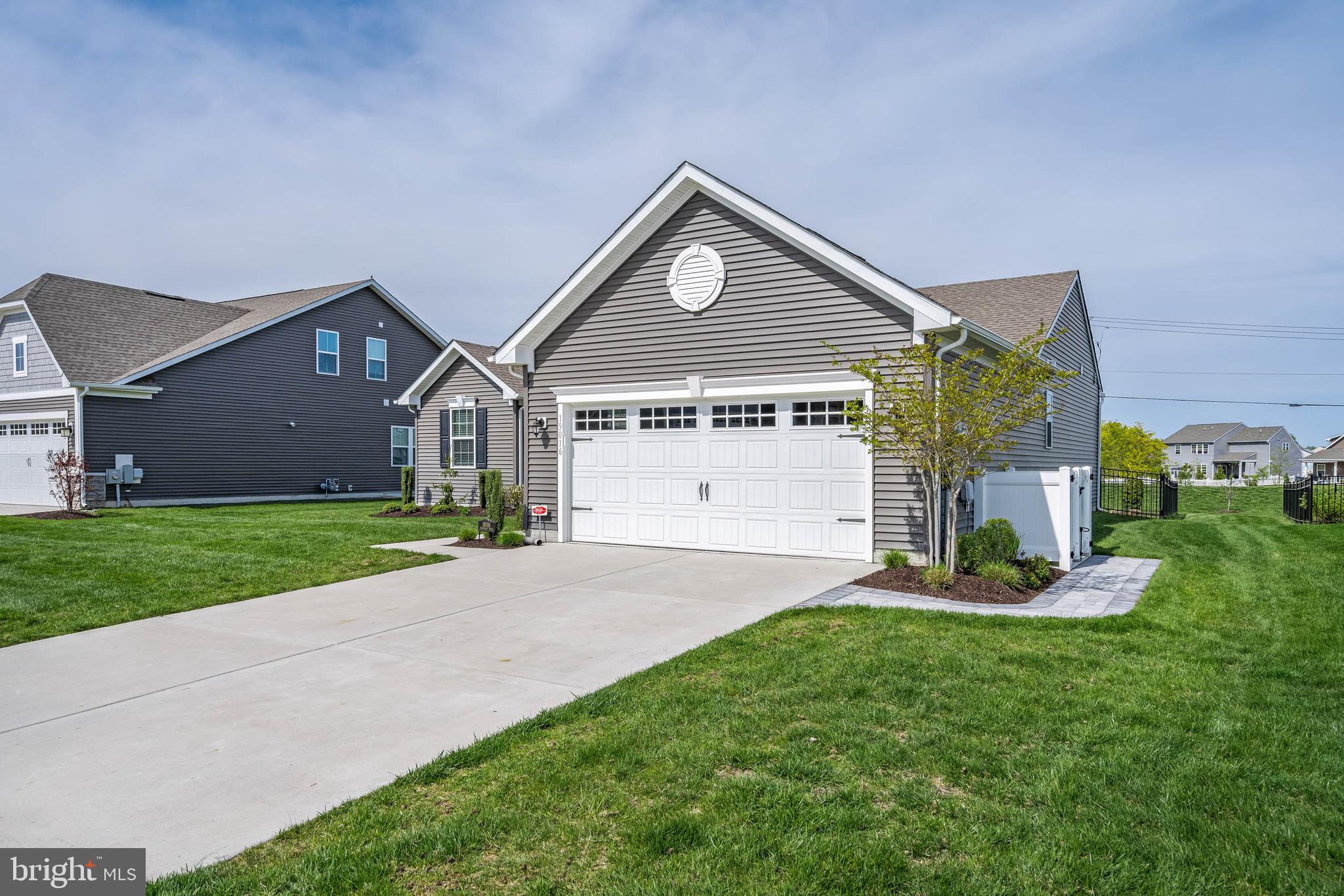 19016 Trimaran Drive Lewes, DE 19958 - Photo 3 of 44 a front view of a house with a yard and garage