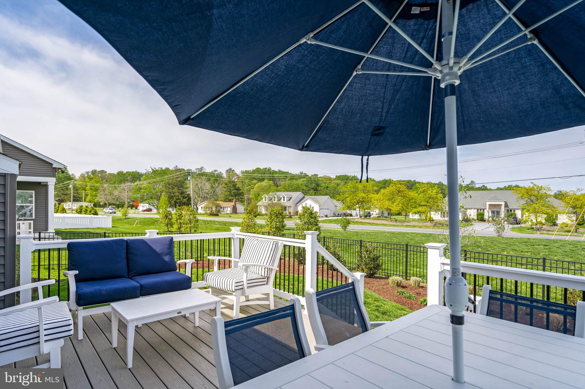 19016 Trimaran Drive Lewes, DE 19958 - Photo 31 of 44 a view of a balcony with wooden floor and outdoor seating