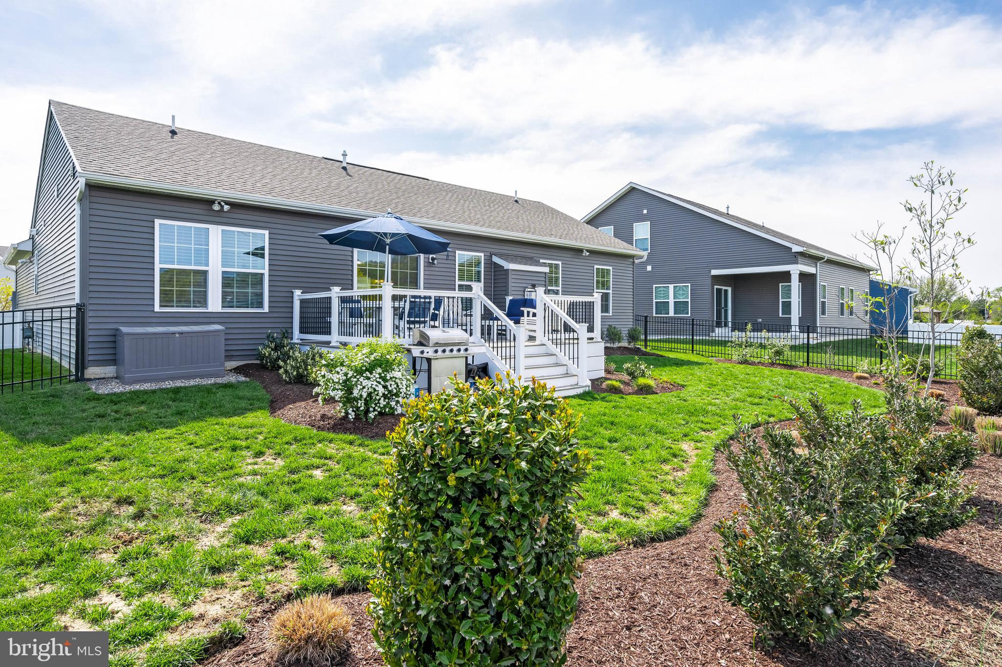 19016 Trimaran Drive Lewes, DE 19958 - Photo 34 of 44 a front view of house with yard and green space