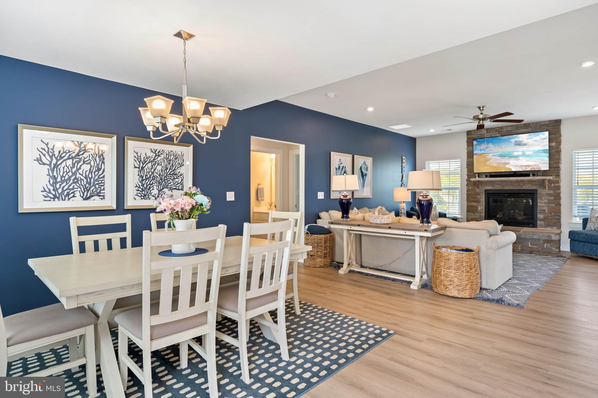 19016 Trimaran Drive Lewes, DE 19958 - Photo 5 of 44 a view of a dining room with furniture a chandelier and wooden floor