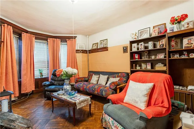 a living room with furniture a rug and a large window