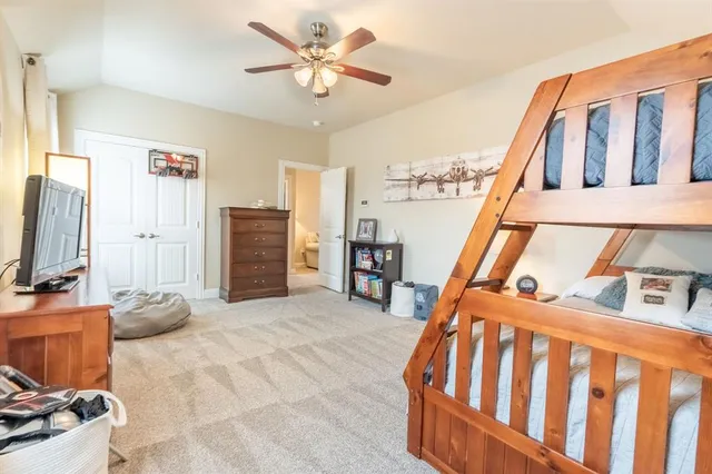 a bedroom with furniture and a flat screen tv