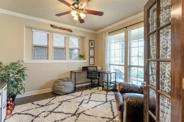 a living room with furniture and floor to ceiling windows