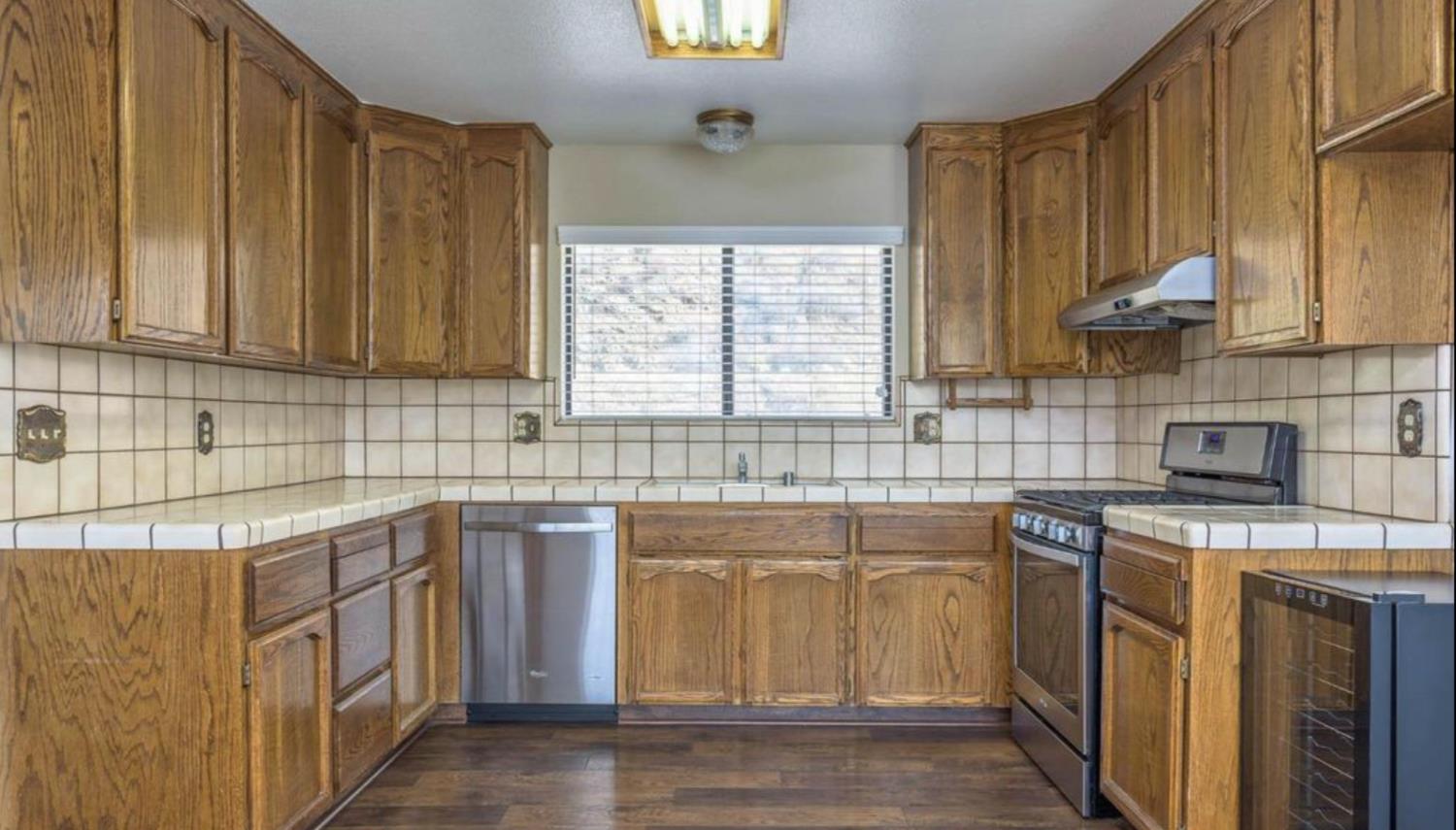 27817 Sky Harbour Road Friant, CA 93626 - Photo 10 of 36 a kitchen with stainless steel appliances granite countertop a sink stove and cabinets