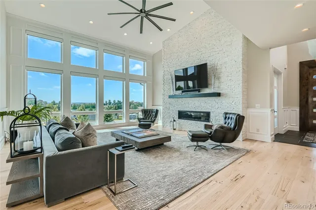 a living room with furniture tv and a fireplace