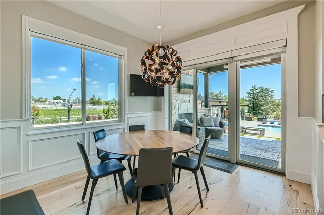 a view of a dining room with furniture and chandelier