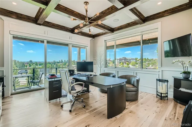 a view of a workspace with furniture and a window