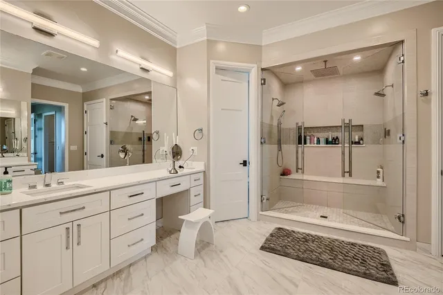 a spacious bathroom with a double vanity sink mirror and bathtub