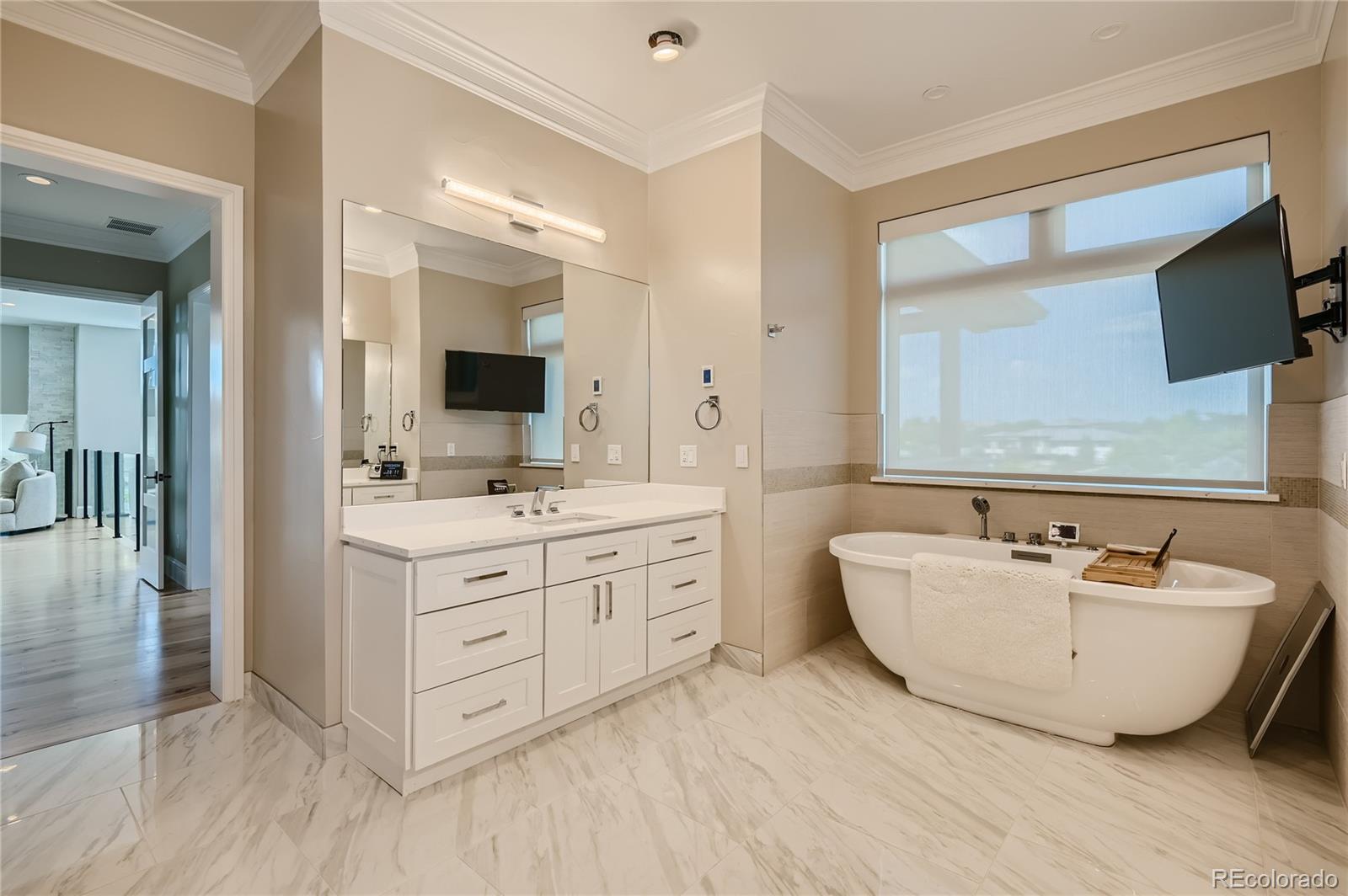 1757 Whistlepig Lane Broomfield, CO 80020 - Photo 31 of 50 a spacious bathroom with a double vanity sink mirror and bathtub