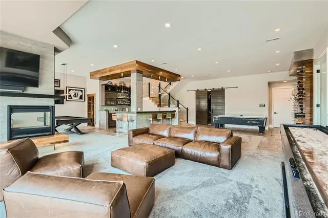 a living room with furniture and large windows