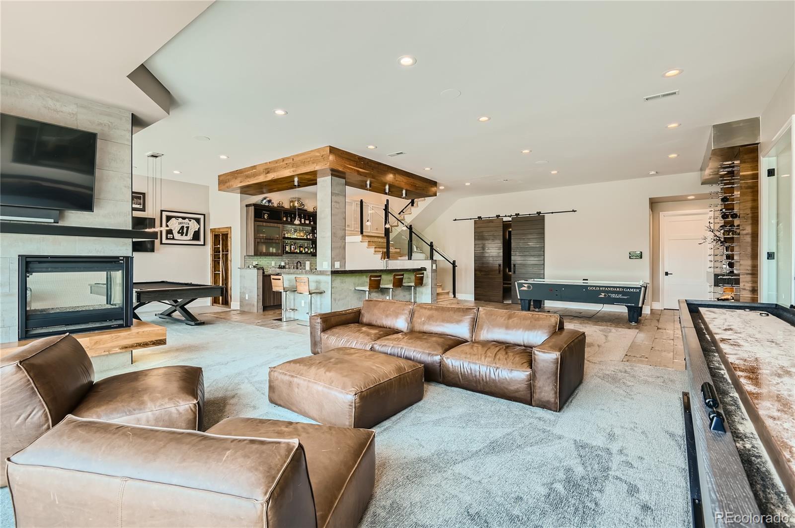 1757 Whistlepig Lane Broomfield, CO 80020 - Photo 36 of 50 a living room with fireplace furniture and a flat screen tv