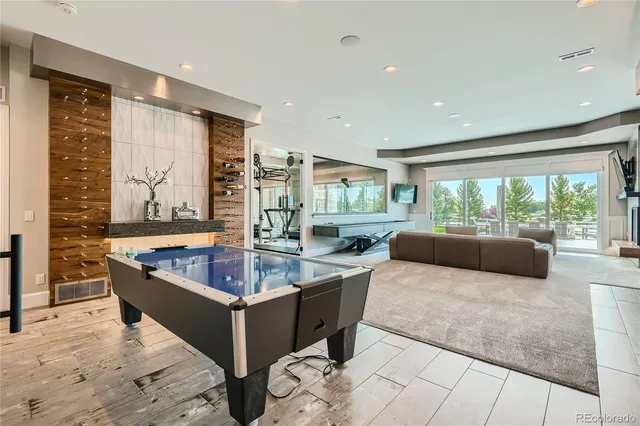 a living room with furniture large window and flat screen tv