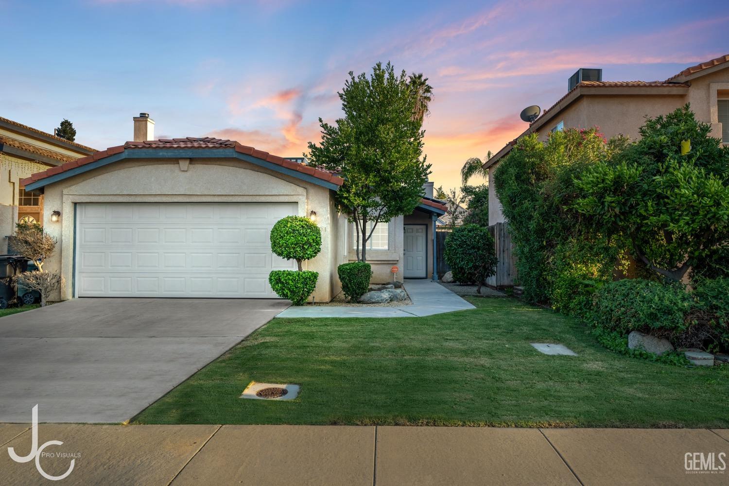 Undisclosed Address Bakersfield, CA 93311 - Photo 1 of 20 a front view of a house with a yard and garage