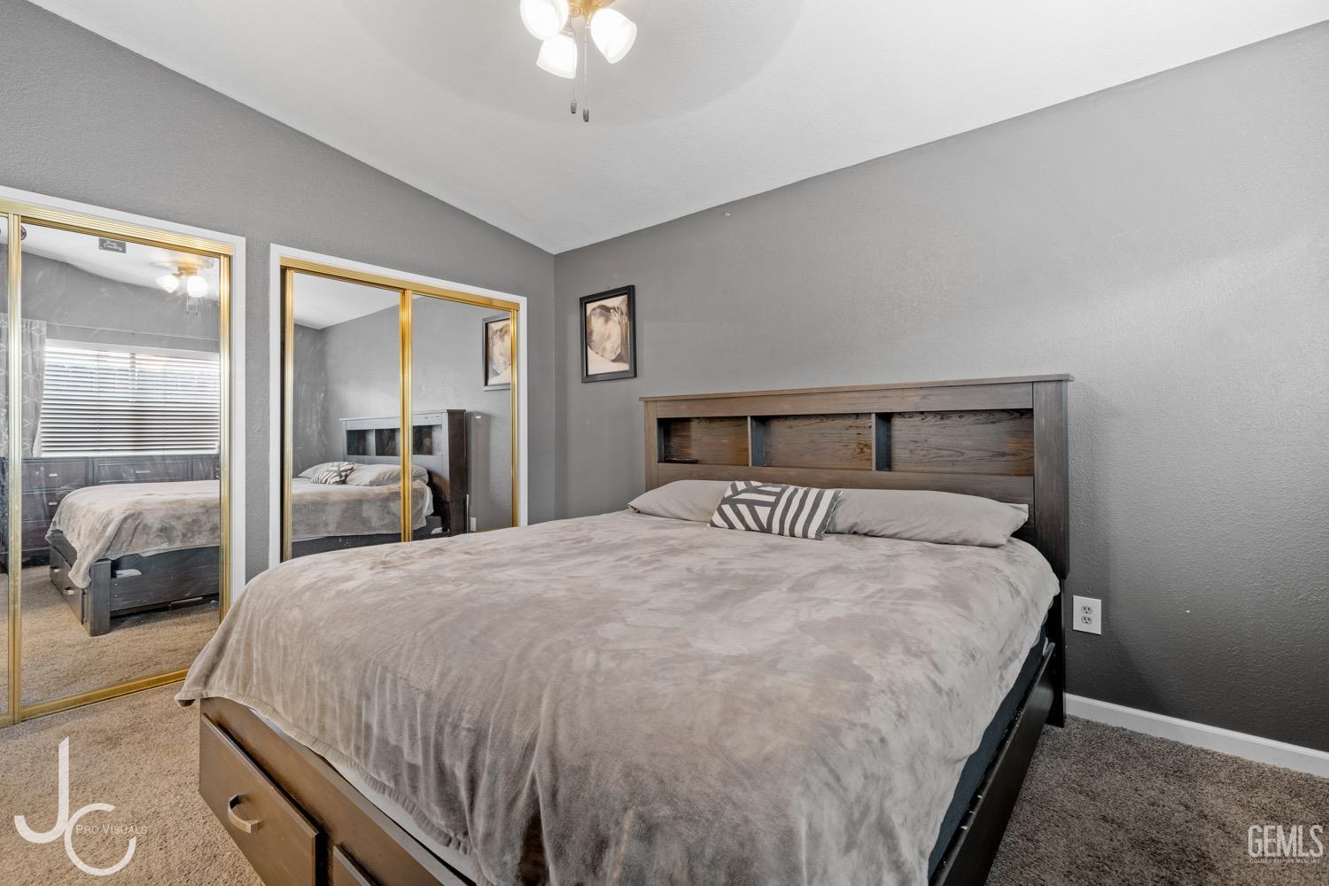 Undisclosed Address Bakersfield, CA 93311 - Photo 14 of 20 a bedroom with a bed and a chandelier