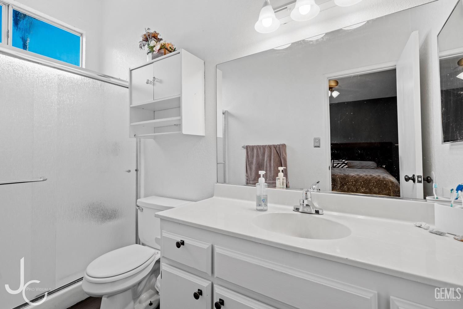Undisclosed Address Bakersfield, CA 93311 - Photo 15 of 20 a bathroom with a sink a toilet and a mirror
