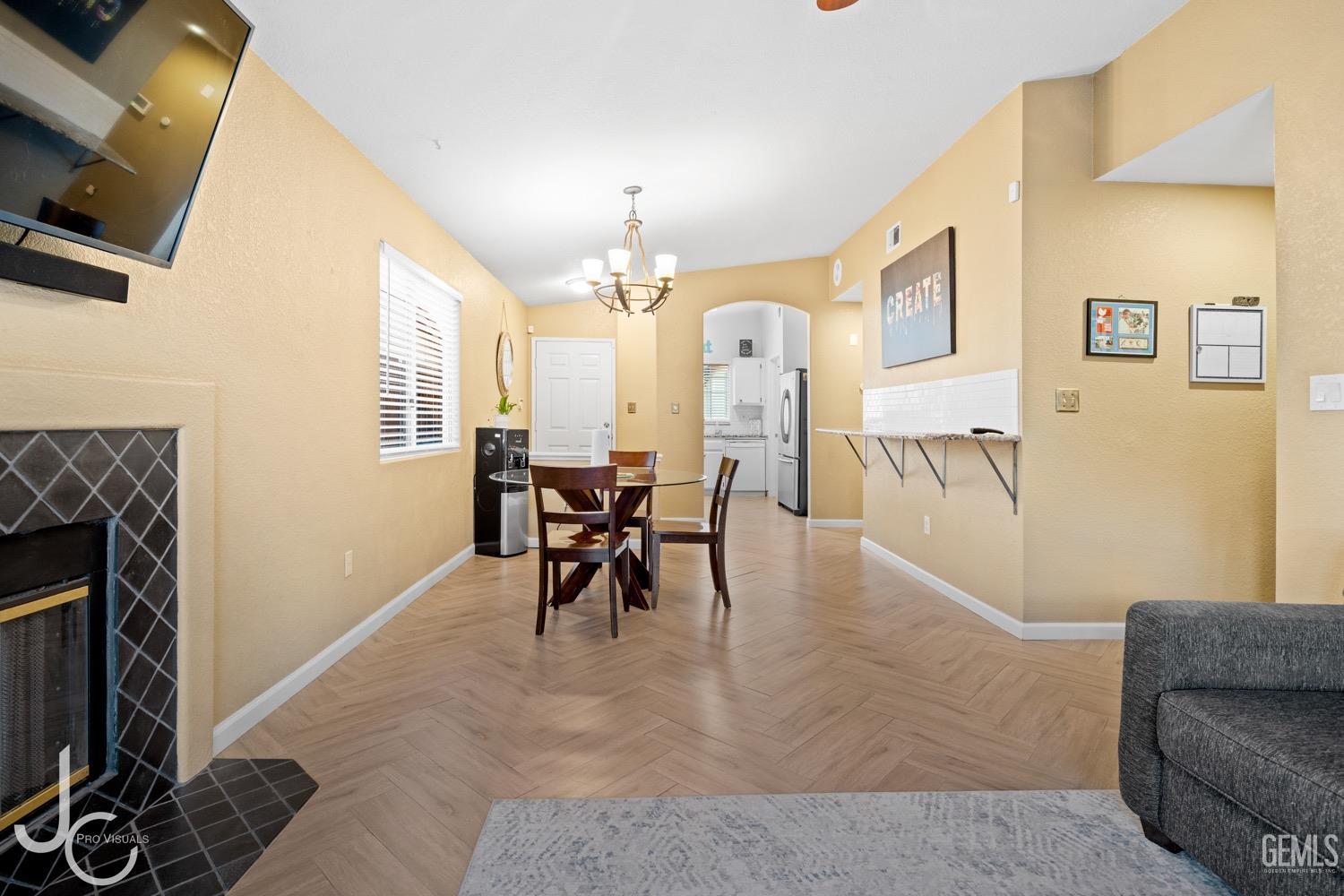 Undisclosed Address Bakersfield, CA 93311 - Photo 6 of 20 a dining room with furniture and a fireplace