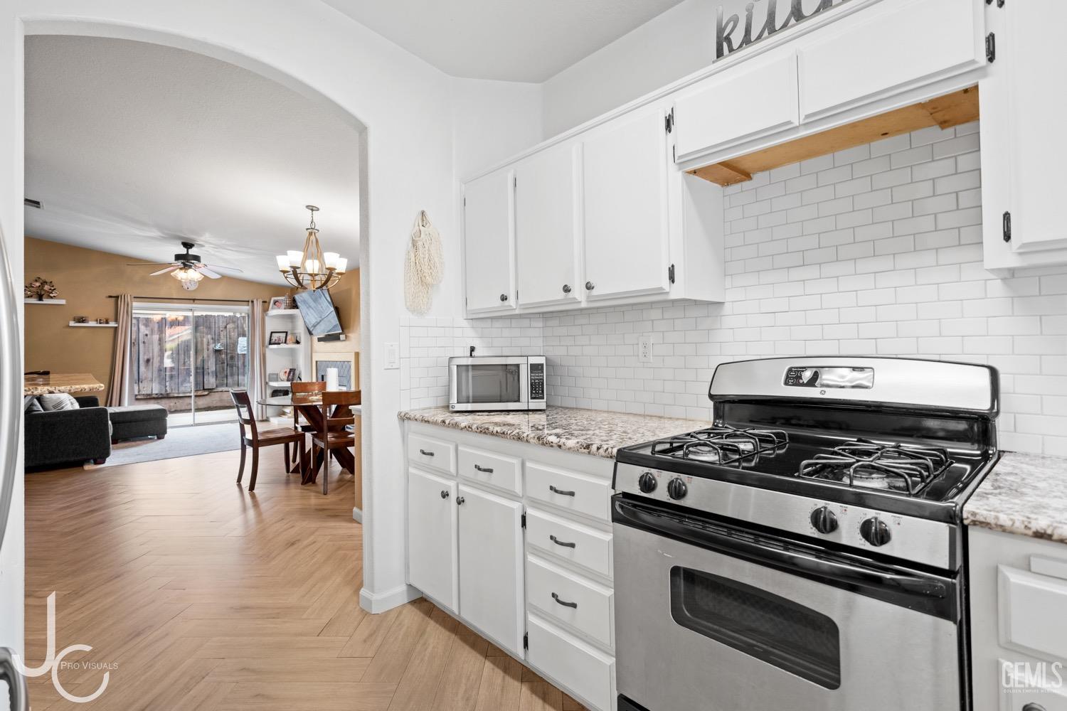 Undisclosed Address Bakersfield, CA 93311 - Photo 7 of 20 a kitchen with stove and cabinets