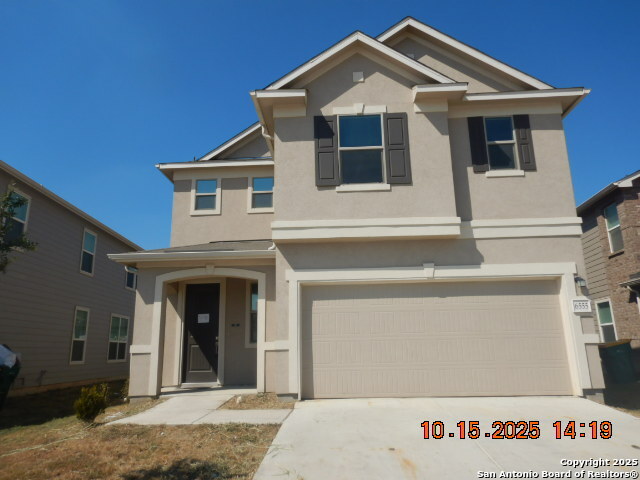 a front view of a house with garage