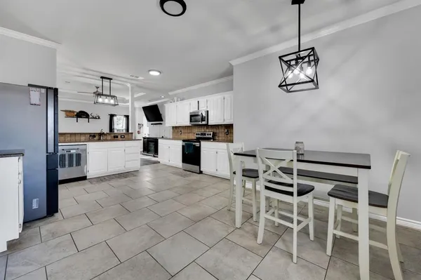 a kitchen with stainless steel appliances granite countertop a sink and a refrigerator