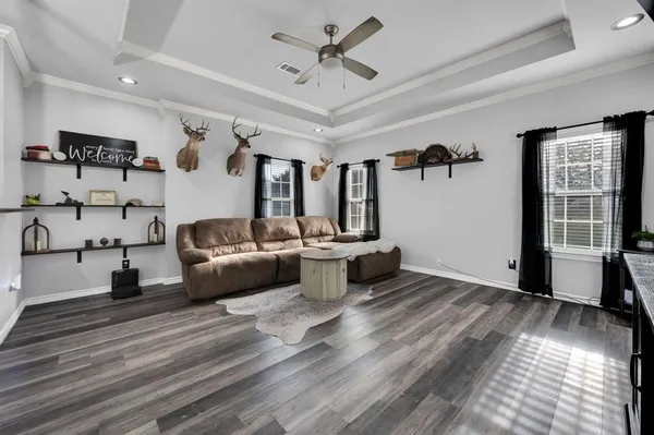 a living room with furniture and wooden floor