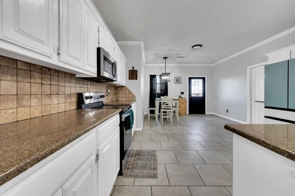 a kitchen with stainless steel appliances granite countertop a sink and cabinets