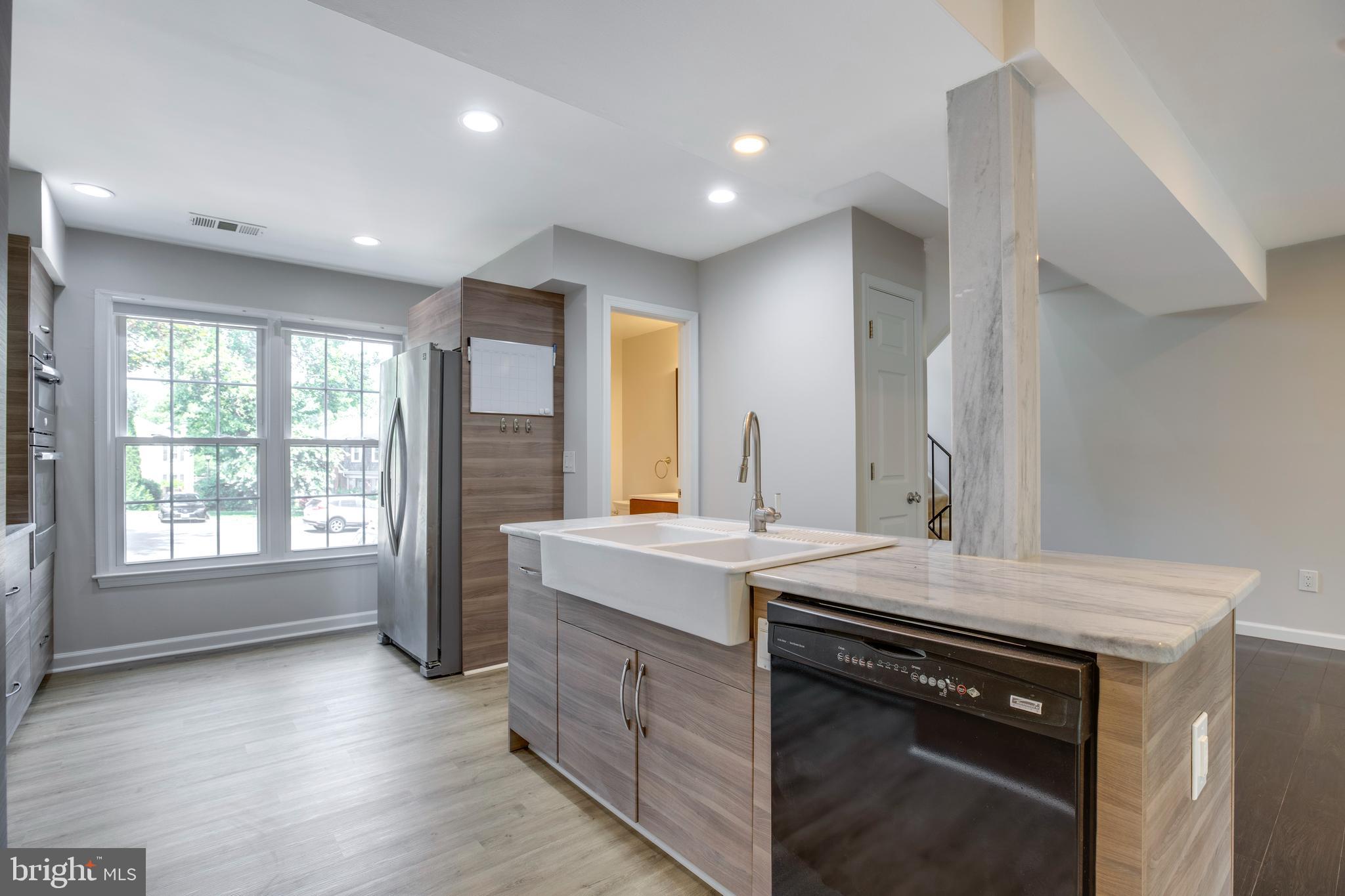 9513 Burdett Road Burke, VA 22015 - Photo 11 of 40 a kitchen with a stove sink and cabinets