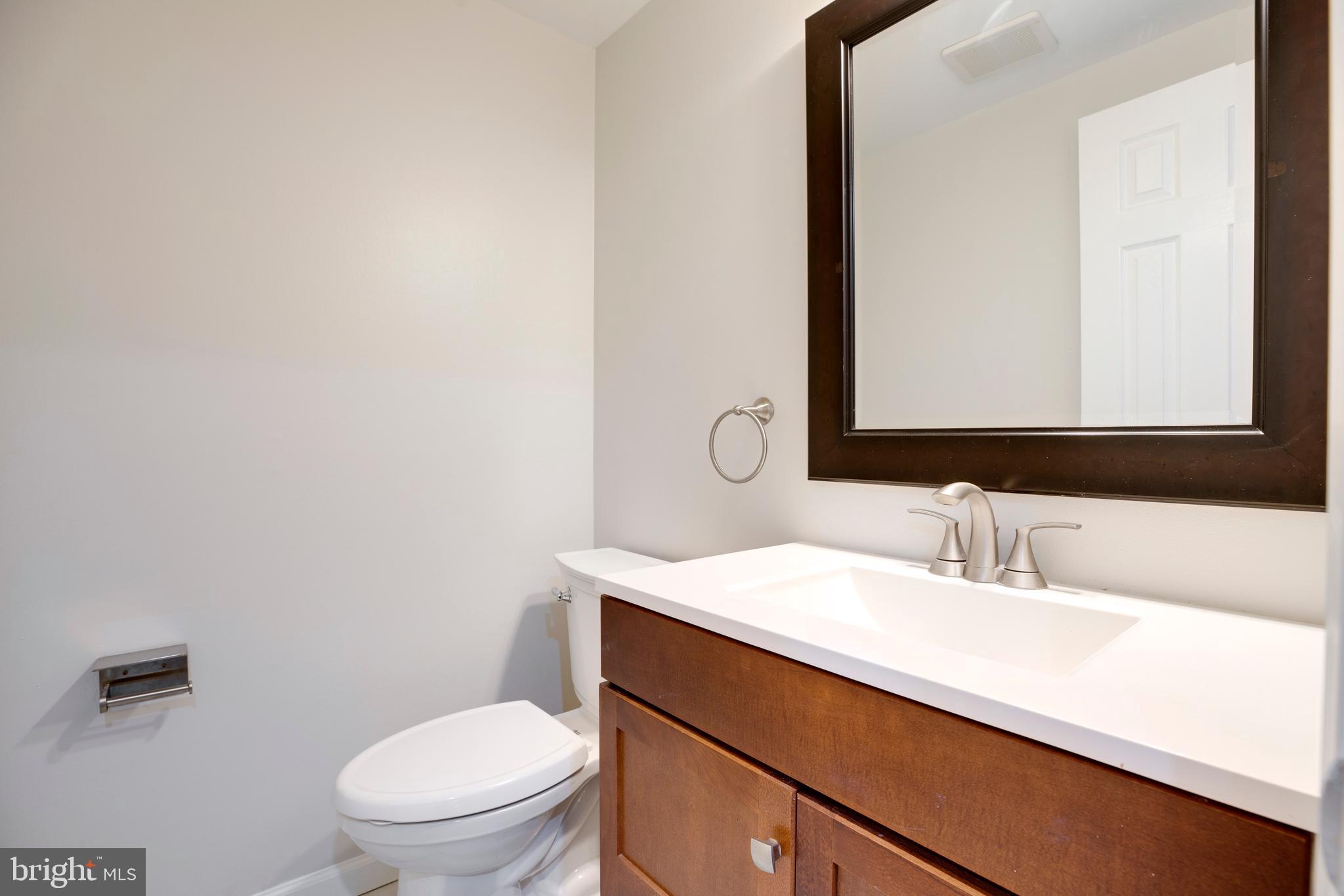 9513 Burdett Road Burke, VA 22015 - Photo 13 of 40 a bathroom with a sink a toilet and mirror