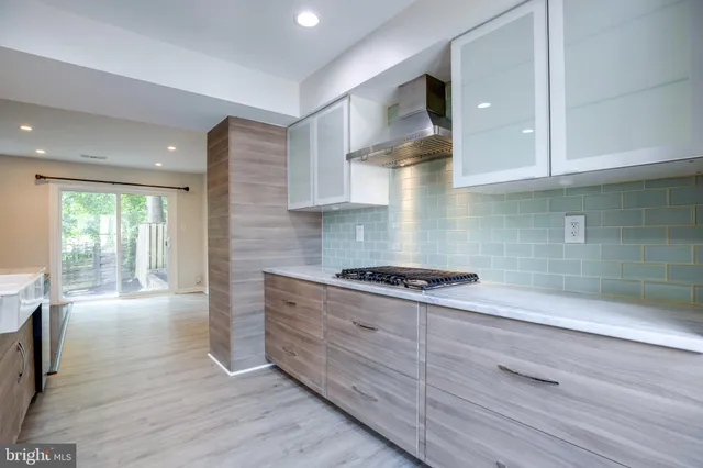 a kitchen with granite countertop wooden cabinets and white appliances