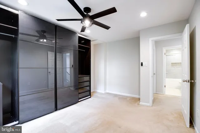 an empty room with closet and windows