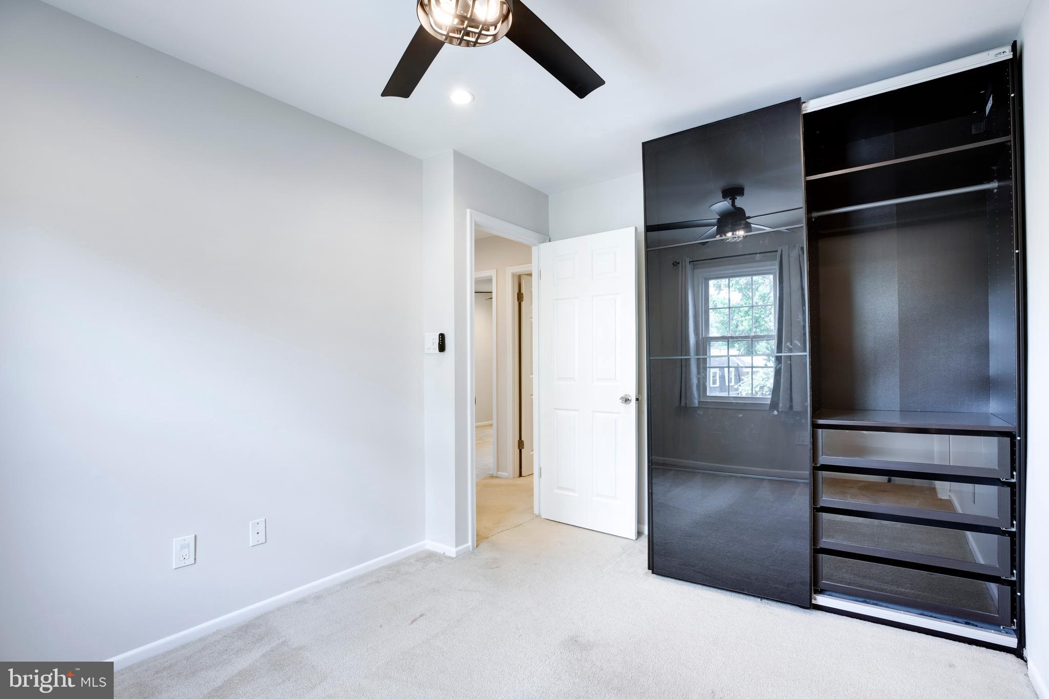 9513 Burdett Road Burke, VA 22015 - Photo 23 of 40 an empty room with closet and windows