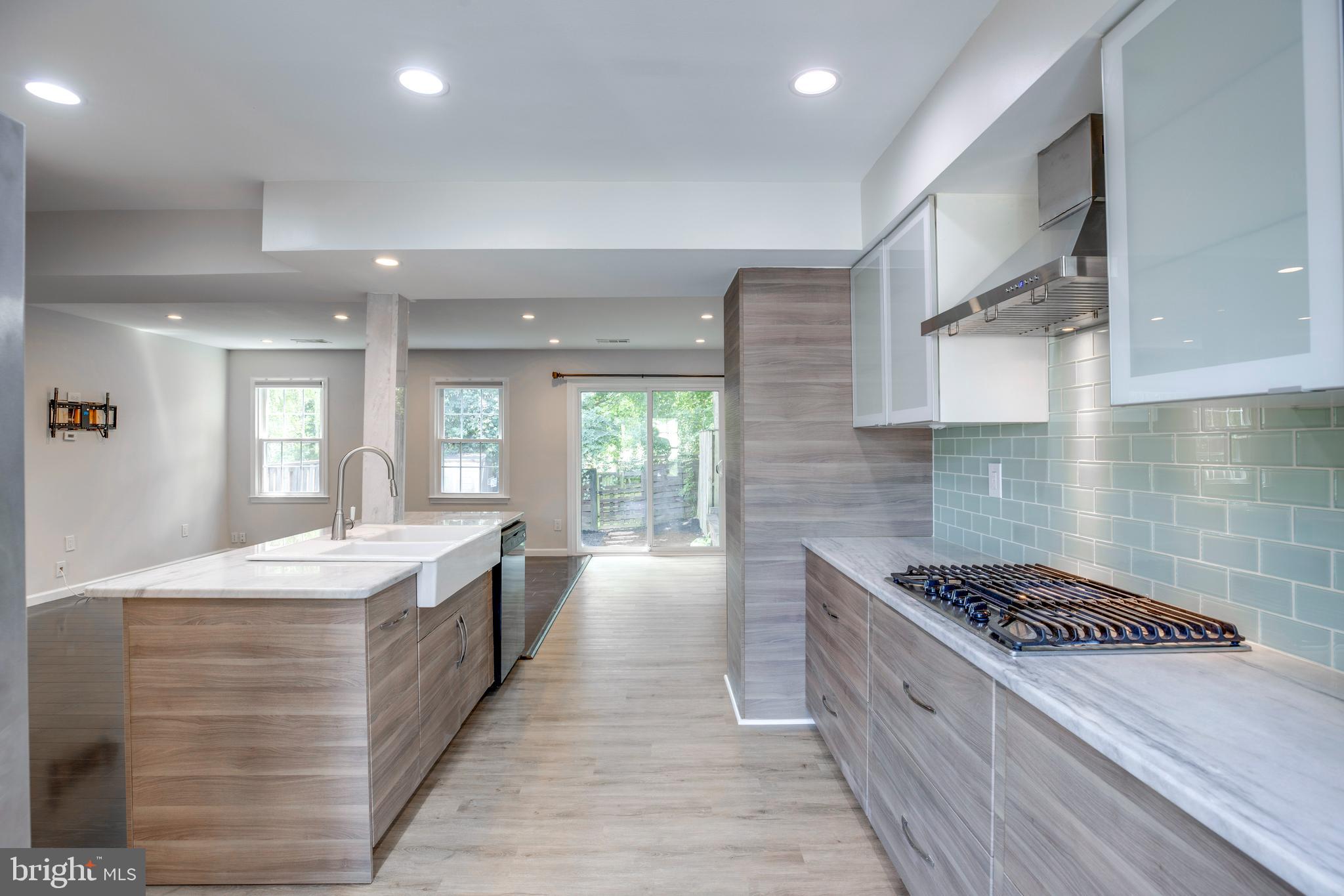 9513 Burdett Road Burke, VA 22015 - Photo 3 of 40 a large kitchen with kitchen island a sink stainless steel appliances and cabinets
