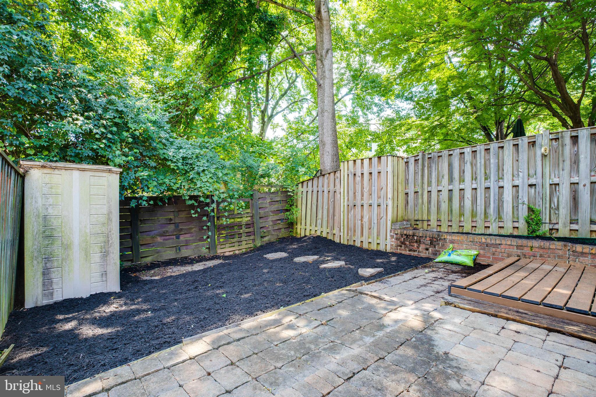 9513 Burdett Road Burke, VA 22015 - Photo 31 of 40 a view of a backyard with a large tree and wooden fence