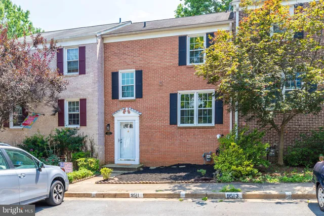 a view of a street with houses on both side