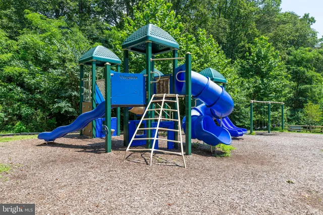 a view of a backyard with wooden fence