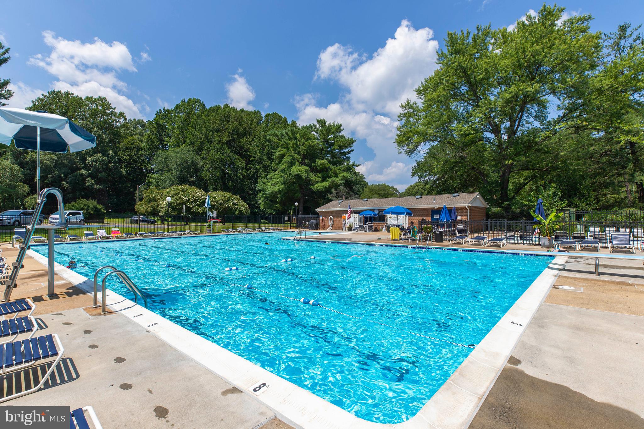 9513 Burdett Road Burke, VA 22015 - Photo 38 of 40 a childrens park with lots of swings slides and swimming pool